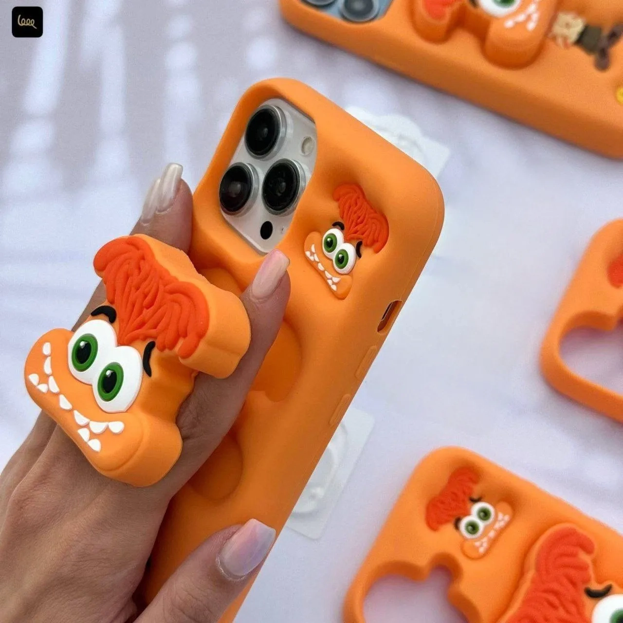قاب گوشی آیفون سیلیکونی نارنجی طرح عروسکی شخصیت اضطراب با استند قاب گوشی آیفون سیلیکونی نارنجی طرح عروسکی شخصیت اضطراب با استند